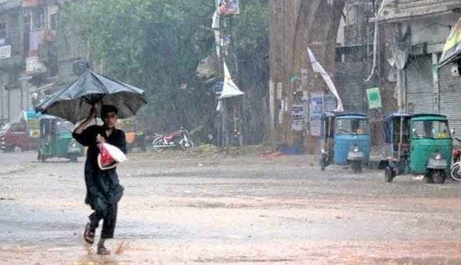 RAIN IN PAKISTAN A BOY KEEPING HIMSELF SAVE FROM RAIN